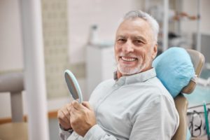 man smiling after dental implant surgery 