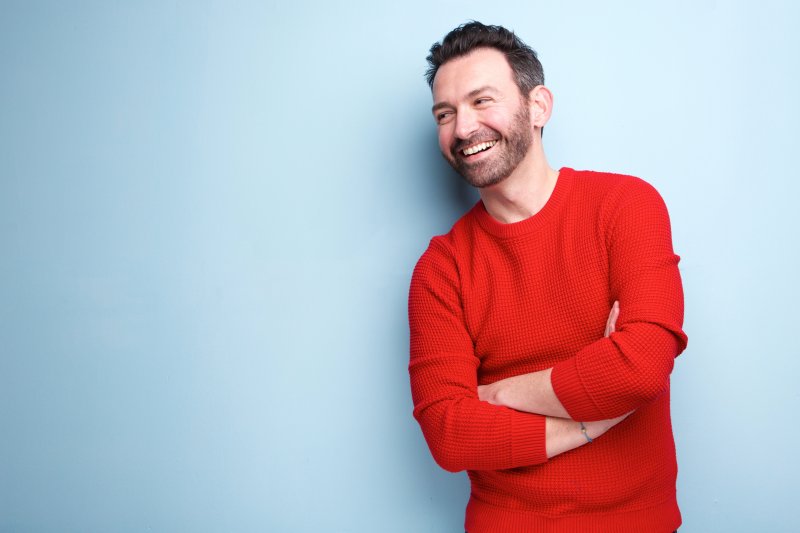 man smiling about veneers or crowns in Orange