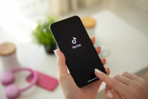 Opening the TikTok app on a smartphone