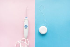 Waterpik and dental floss side-by-side comparison
