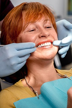 Woman smiling at dentist in Orange