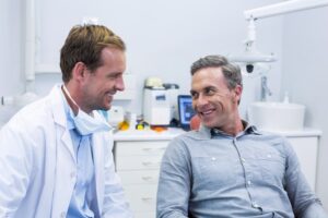 person speaking with dentist about getting dental implants