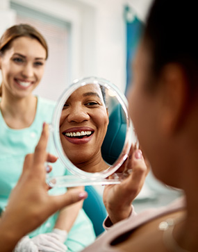 Woman sharing beautiful smile thanks to Orange California Invisalign clear braces