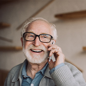 Dentures patient in Orange talking on the phone