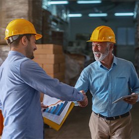 Dentures patient in Orange shaking hands with a client