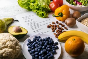 Healthy foods arranged around a paper recipe