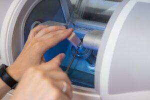 Dentist putting block of porcelain into CEREC machine