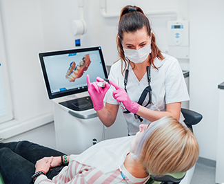 Dental assistant showing patient clear aligner