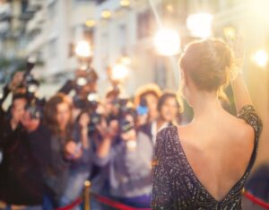 Mysterious celebrity smiling on red carpet with dental implants
