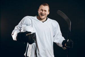 Hockey player smiling and showing missing tooth.